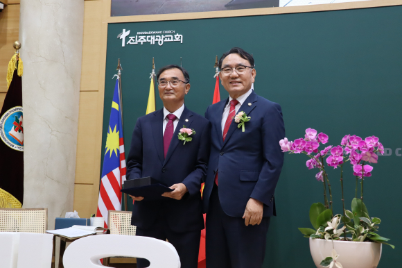 전국남전도회 수석부회장이 장재권 회장에게 공로패를 증정하고 있다.